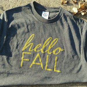 A 100% cotton t shirt that says "Hello Fall"